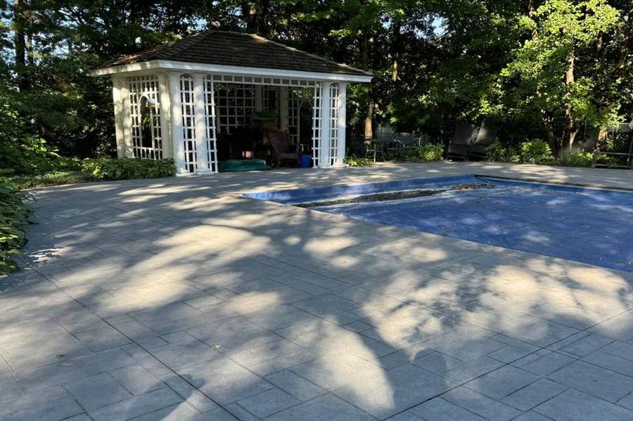 Before: dull, gray stamped pool deck