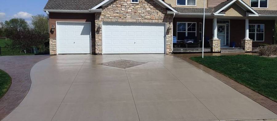 After: the same driveway sealed, with deeper, even color